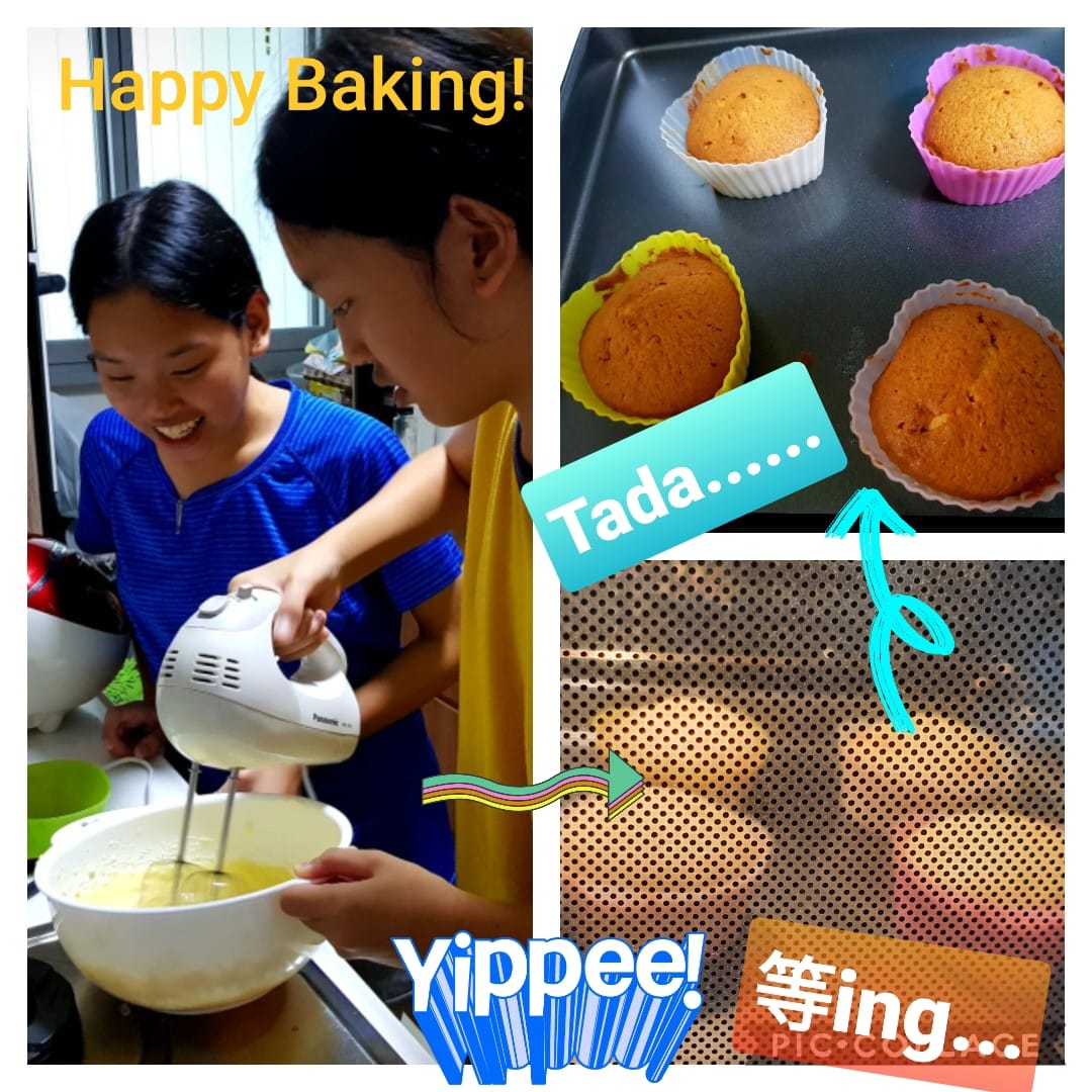Two girls mixing batter with a hand mixer, alongside four baked cupcakes in colorful silicone cups on a tray.